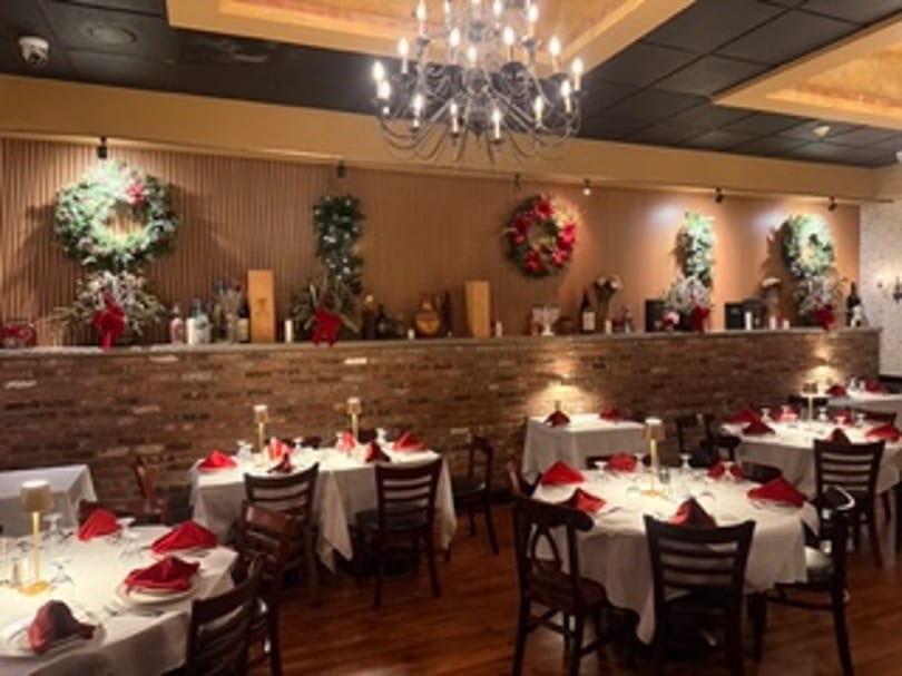 Dining room set with holiday wreaths and red table settings